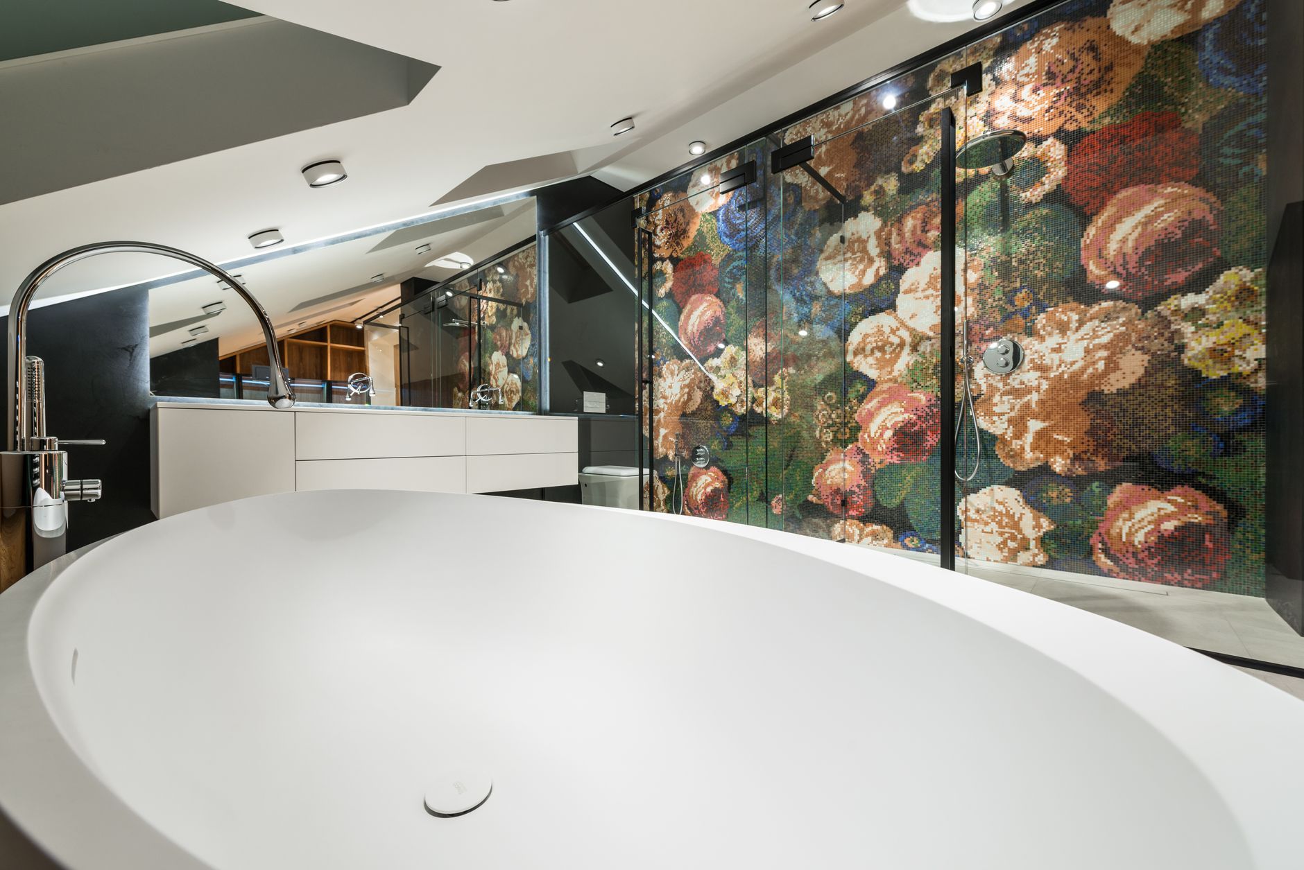 Modern bathroom interior with ceramic tiles, a glass shower cabin, and quality plumbing.
