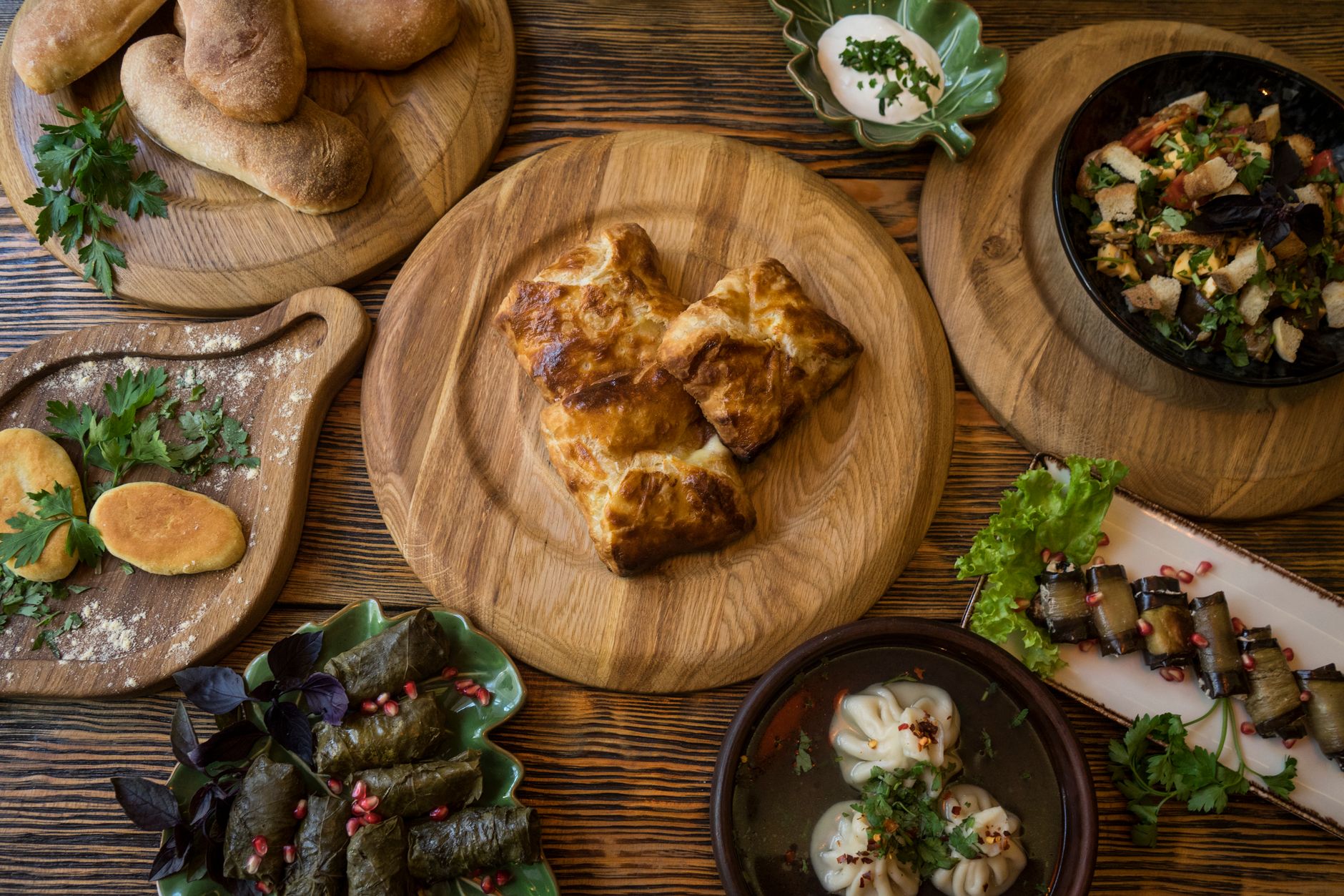A traditional Georgian supra table spread with a variety of dishes and wine in Sighnaghi.
