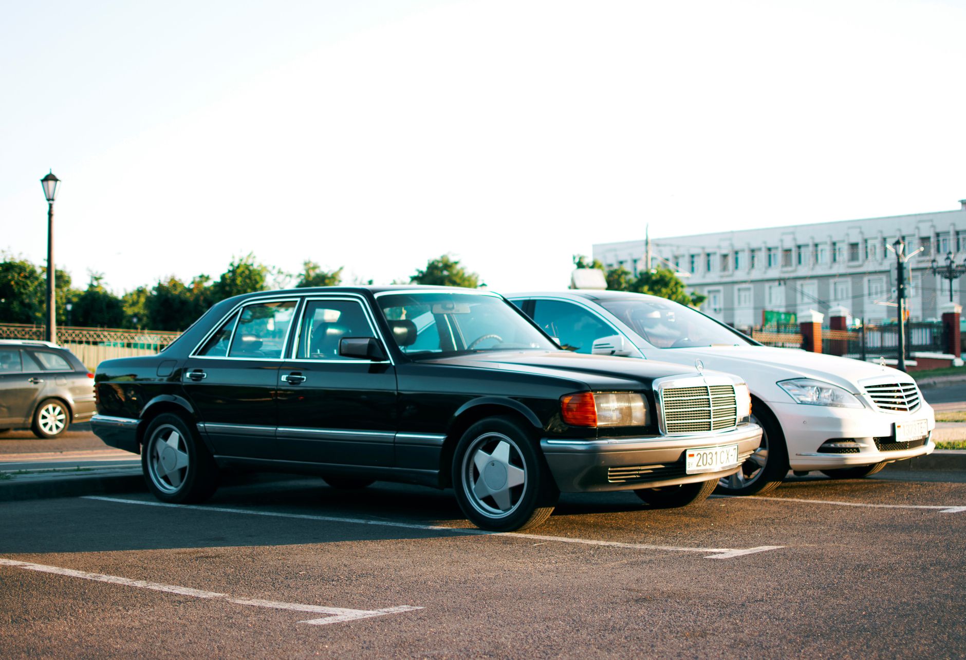 Black premium class car parked in the old district of Tbilisi at sunset