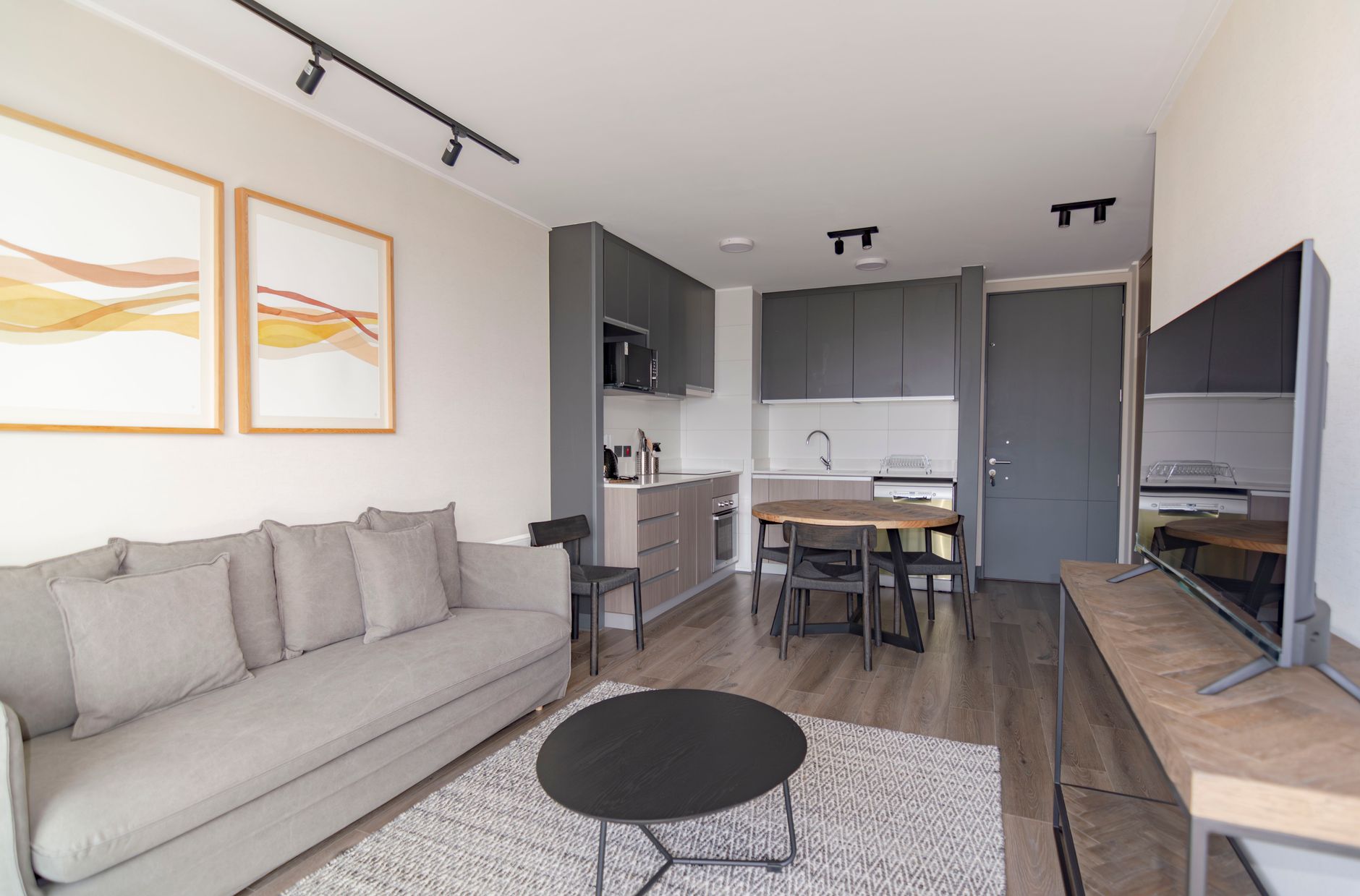 Modern small apartment interior with light colors and multi-functional furniture