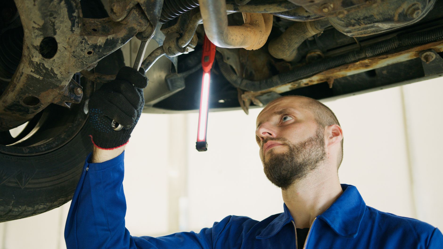 A tourist inspecting the condition of a car before starting a trip