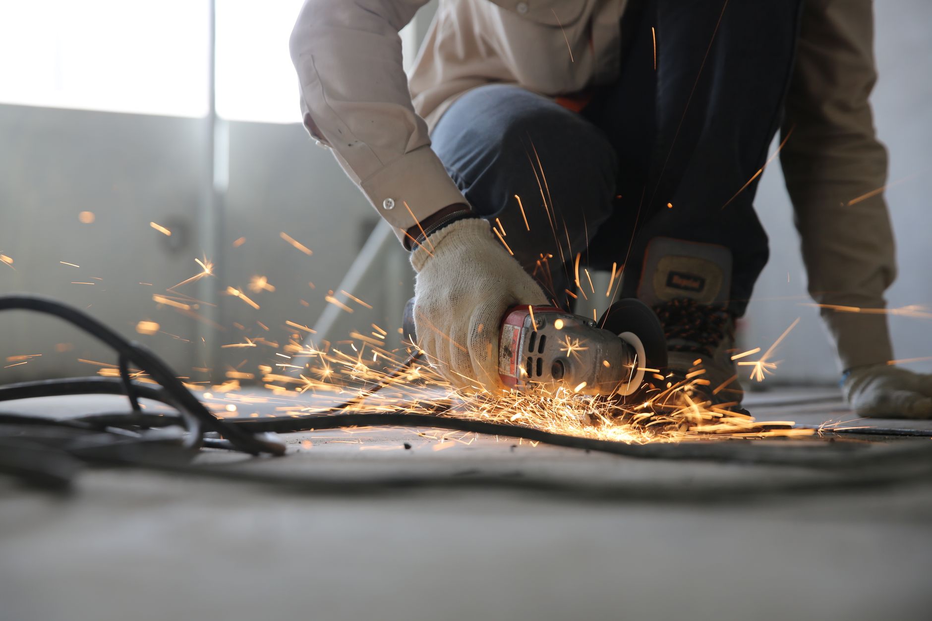 A professional craftsman checking electrical wiring in a modern apartment during renovation