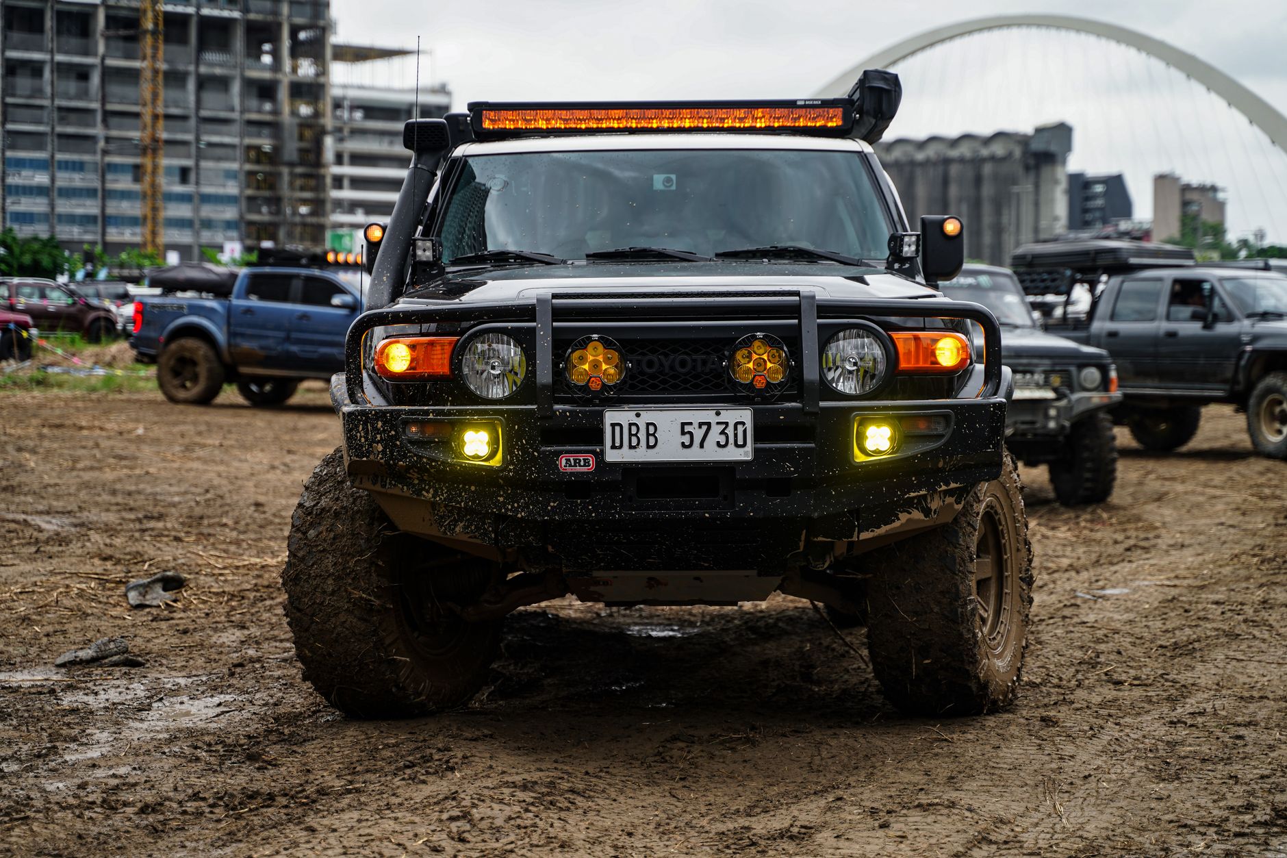 Front view of an SXS with a bright LED light bar installed on a forest trail.