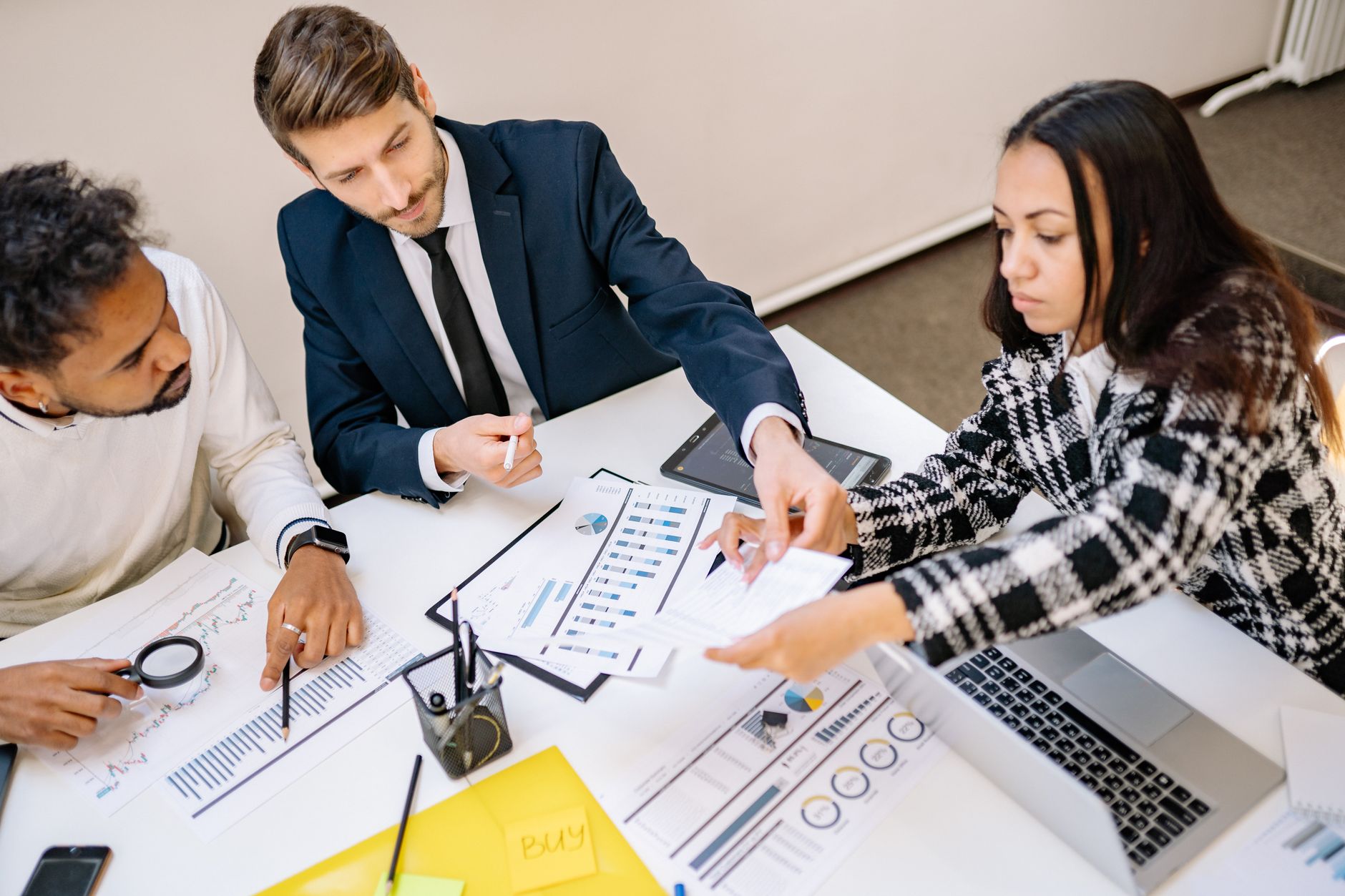 Strategic plan spread on an office desk with charts and colorful sticky notes