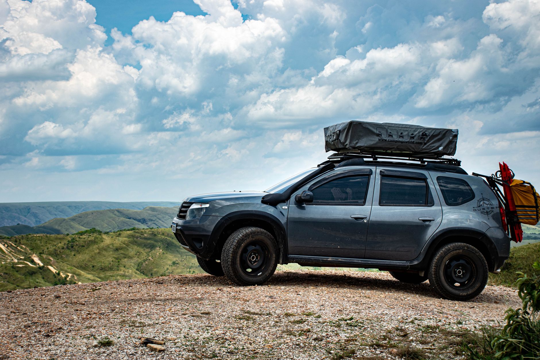 Camping gear and a 4x4 vehicle parked in the wild mountains of Georgia.